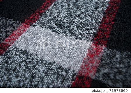 Closeup of red, black and grey woolen scarf texture Closeup of red, black and grey woolen scarf texture 71978669