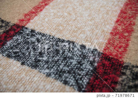 Closeup of beige and black woolen scarf texture Closeup of beige and black woolen scarf texture 71978671