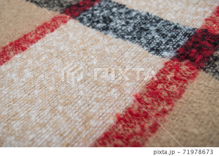 Closeup of beige and black woolen scarf texture Closeup of beige and black woolen scarf texture 71978673