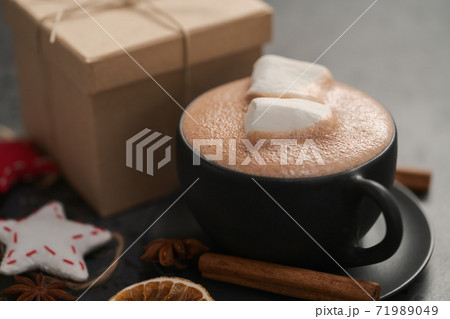 Hot chocolate in a black cup with christmas decorations 71989049