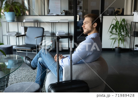 Capable millennial male expert travelling on business waiting for meeting 71989428