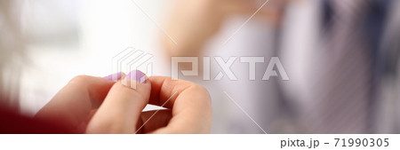 Focused photo on woman that holding hands together Focused photo on woman that holding hands together 71990305