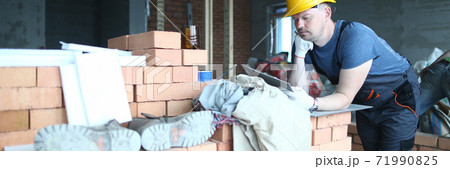 Concentrated young builder creating plan of action Concentrated young builder creating plan of action 71990825