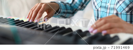 Close up of female hands that playing the piano 71991469