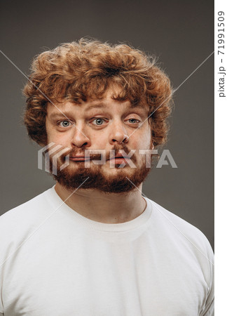 Young man with dual emotions combination on face isolated on dark background, emotional and expressive Young man with dual emotions combination on face isolated on dark background, emotional and expressive 71991509