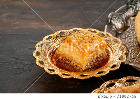 Piece of Turkish baklava in golden arabic plate 71992758