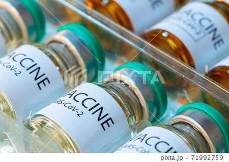 Vaccine vials of Sars-cov-2 on table in laboratory . Vaccine vials of Sars-cov-2 on table in laboratory . 71992759