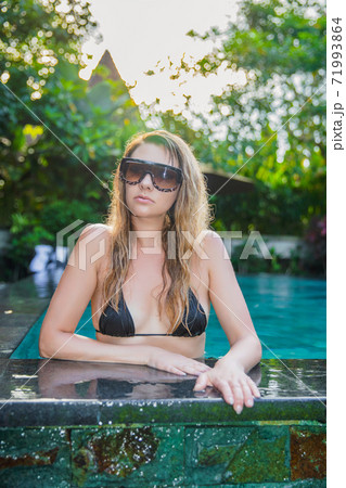 Nice woman dressed in black swimsuit 71993864