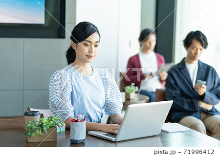 コワーキングスペースでパソコン作業をする若い女性 71996412
