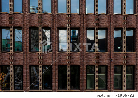 Reflection of the city in the glass of a historic industrial building Reflection of the city in the glass of a historic industrial building 71996732