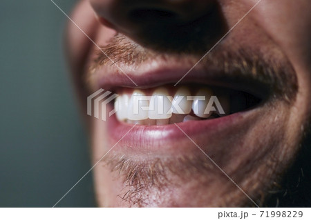 Toothy smile of young man Toothy smile of young man 71998229