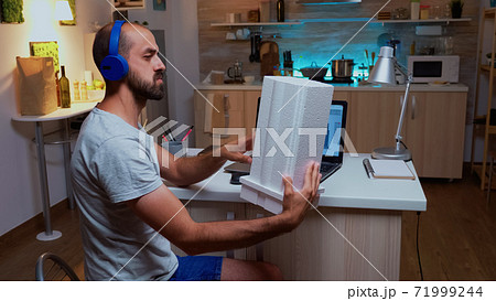 Architect holding building model while working on a project 71999244