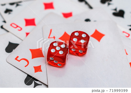 The dice are laid on top of the cards with a winning combination The dice are laid on top of the cards with a winning combination 71999399