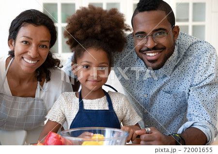 Portrait of happy black family of three at modern kitchen 72001655
