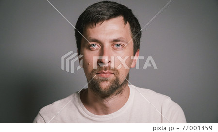 Portrait of sick young man with runny nose, suffering from cold or flu and sneezing while sitting in bed at home. Virus or allergy. Disease. Male is ill. Infection, epidemic, carrier of bacteria 72001859