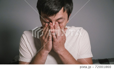 A young Caucasian male has a cold and has a runny nose. The male at home in bed sneezes due to the seasonal virus. The guy suffers from allergies and suffers. Human flu. Can't believe I'm sick again A young Caucasian male has a cold and has a runny nose. The male at home in bed sneezes due to the seasonal virus. The guy suffers from allergies and suffers. Human flu. Can't believe I'm sick again 72001860