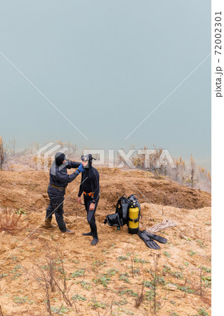 Lifeguard in a wetsuit to work underwater. Search at the bottom of the pond. 72002301