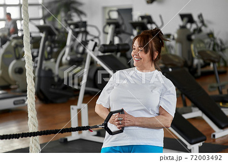 Older woman exercises in modern gym. 72003492