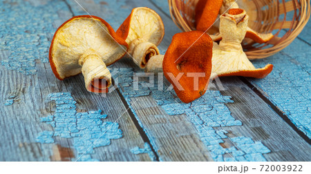 orange mushrooms on a wooden background. selective, blurred focus. tangerine mushrooms, creative product.  72003922