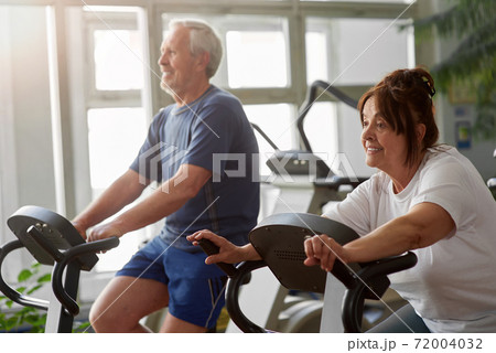 Elderly woman working out in modern gym. Elderly woman working out in modern gym. 72004032