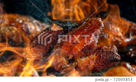 Tasty Chicken Legs on Cast Iron Grate with Fire Flames. Tasty Chicken Legs on Cast Iron Grate with Fire Flames. 72005853