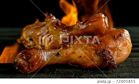 Tasty Chicken Legs on Cast Iron Grate with Fire Flames. Tasty Chicken Legs on Cast Iron Grate with Fire Flames. 72005855
