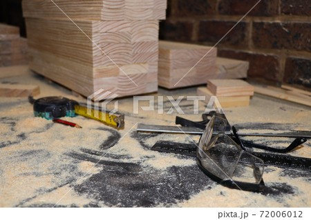 Safety Glasses And Equipment On Dusty Carpentry Bench Safety Glasses And Equipment On Dusty Carpentry Bench 72006012