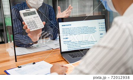 business team brainstorm they are working hard by looking through the plastic protective wall, concept of social distancing to prevent the spread of coronavirus COVID-19 business team brainstorm they are working hard by looking through the plastic protective wall, concept of social distancing to prevent the spread of coronavirus COVID-19 72012938