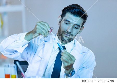 Research scientists analysing test trial new generation vaccine data. Research scientists analysing test trial new generation vaccine data. 72013746