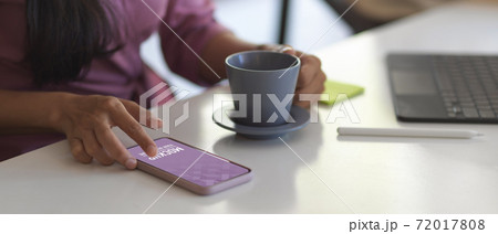 Female using smartphone while take a coffee break in meeting room Female using smartphone while take a coffee break in meeting room 72017808