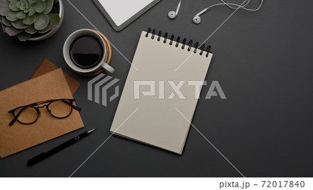 Worktable with blank notebook, coffee cup, glasses, supplies and copy space on the table Worktable with blank notebook, coffee cup, glasses, supplies and copy space on the table 72017840