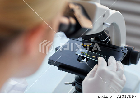 Woman Looking in Microscope Close Up Woman Looking in Microscope Close Up 72017997