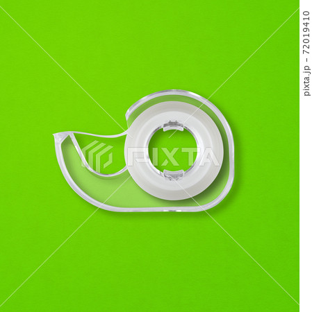 Scotch tape dispenser isolated on green background 72019410