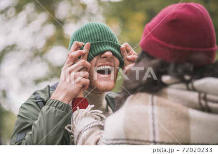 Woman fixing a hat on her partners head 72020233