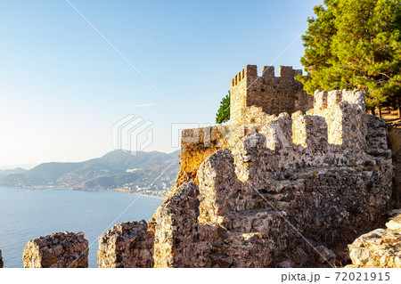 Elements of an ancient fortress. ancient city. Fortress on the rocks. Ruined walls of a medieval castle on the mountain. 72021915