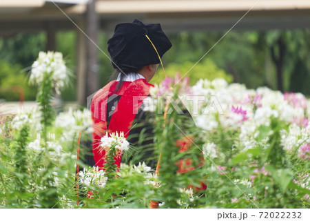 Doctor of Philosophy Graduate Elder Female Taking a Photo in the Beautiful Flower Garden 72022232