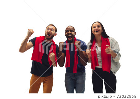 Multiethnic soccer fans cheering for favourite sport team with bright emotions isolated on white studio background Multiethnic soccer fans cheering for favourite sport team with bright emotions isolated on white studio background 72022958