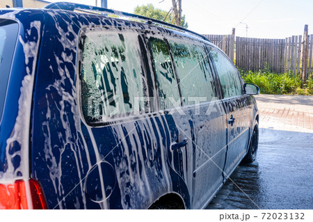 Foam on the car, car wash, self-service at the car wash, washing the car with foam. Foam on the car, car wash, self-service at the car wash, washing the car with foam. 72023132
