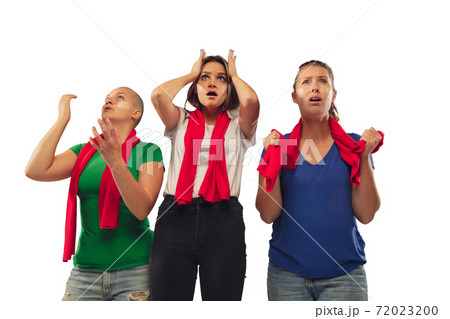 Female soccer fans cheering for favourite sport team with bright emotions isolated on white studio background Female soccer fans cheering for favourite sport team with bright emotions isolated on white studio background 72023200