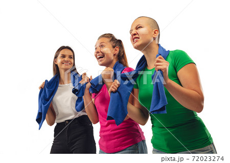 Female soccer fans cheering for favourite sport team with bright emotions isolated on white studio background Female soccer fans cheering for favourite sport team with bright emotions isolated on white studio background 72023274
