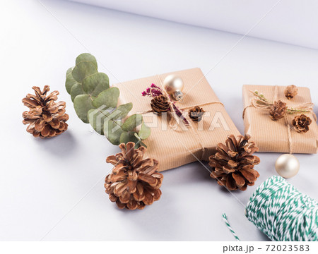 Christmas festive wrapped presents, pine cones Christmas festive wrapped presents, pine cones 72023583