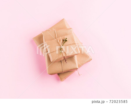 Stack of wrapped zero waste gift box on pink 72023585