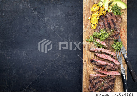 Barbecue dry aged wagyu flank steak with corn, avocado and chimichurri sauce Barbecue dry aged wagyu flank steak with corn, avocado and chimichurri sauce 72024132
