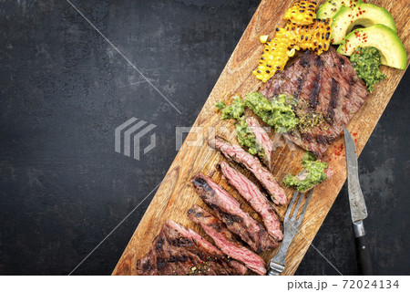 Barbecue dry aged wagyu flank steak with corn, avocado and chimichurri sauce Barbecue dry aged wagyu flank steak with corn, avocado and chimichurri sauce 72024134