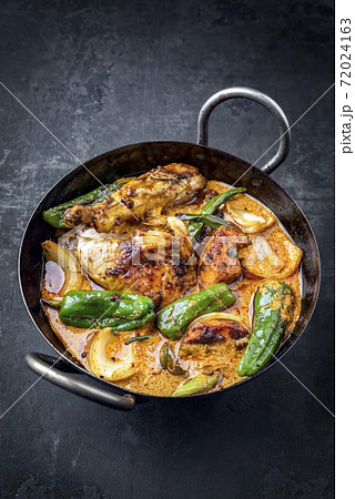 Traditional Thai kaeng massaman coconut chicken curry with jalapeno, poblano chili and sweet potato 72024163