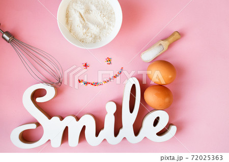 Ingredients for cooking baking - flour, egg, sugar, rolling pin on pink background. Concept of cooking dessert Ingredients for cooking baking - flour, egg, sugar, rolling pin on pink background. Concept of cooking dessert 72025363