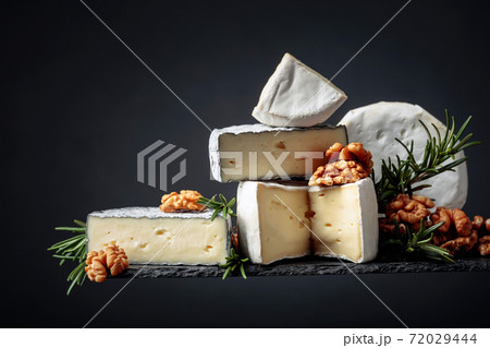 Various soft cheeses with walnuts and rosemary. Various soft cheeses with walnuts and rosemary. 72029444