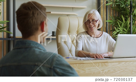 Elderly female boss communicate with subordinate. Recruiting new candidate at job interview 72030137