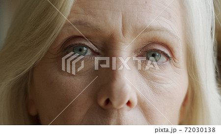 The face and eyes of the old woman. Large wrinkles on the old woman's face. Face close up 72030138