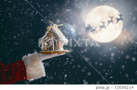 Gingerbread house in the hand. Gingerbread house in the hand. 72030214